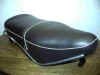The large seat has the grab strap going through grommets. It has the later chromed steel grab handles.