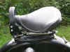 This is a fairly rare solo seat. It mounts to the small rear fender rack. It was made by Pagusa.