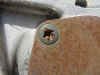 This is an example of a stripped Phillips head screw on an oil cover of a /6 engine. It looks hopeless, but it can be removed quite easily. I would use my hand impact tool. Make absolutely sure that you have the correct sized bit. Then dip the end into valve grinding paste. The paste is made up of ground up silicate, or common sand. The small particles will take up a bit of space, but mostly they will really grab both the Phillips tip and the seemingly ruined screw. Hold the impact tool tightly and give it small taps at first to see that the tip seats as well as it possibly can into the screw head. Hold the impact in the direction for unscrewing or counter clockwise for most fasteners. Now give it a hit.