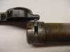 This shows the tang inserted into the groove to hold it in place.
