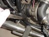 This photo shows a lever being used to slightly compress the clutch spring to get enough slack to remove the cable.